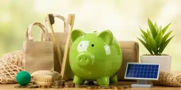 Green piggy bank surrounded by sustainable items, representing financial savings through eco-friendly living.
